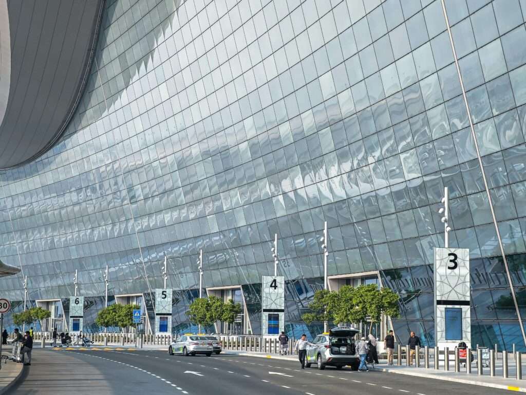 Stunning modern facade of an airport terminal in Abu Dhabi with reflective glass and contemporary design.