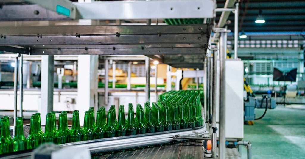 Streamlined glass bottle manufacturing process in factory setting, showcasing assembly line automation.